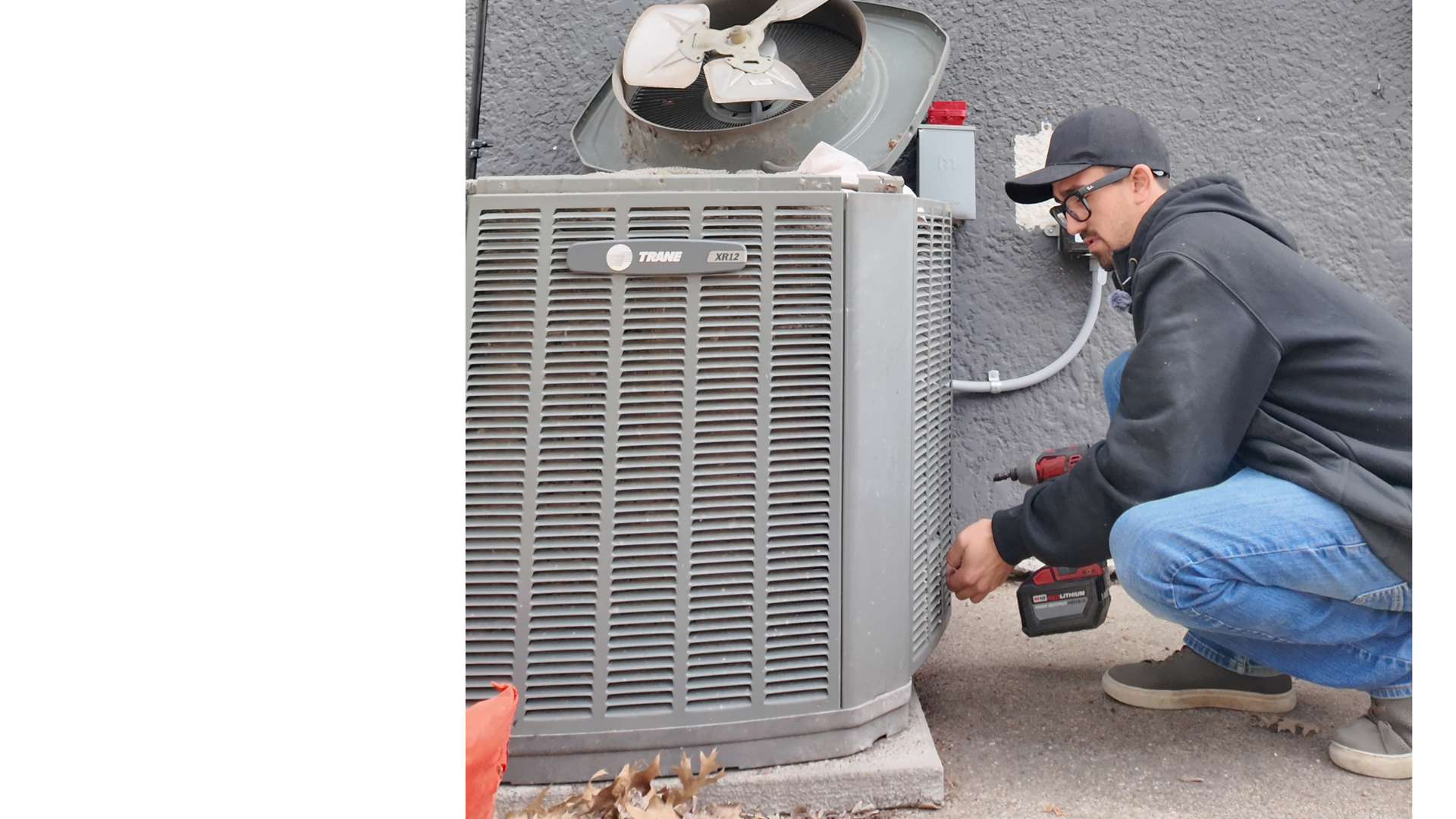 Justin Fodor inspecting a GE condenser unit on a service call